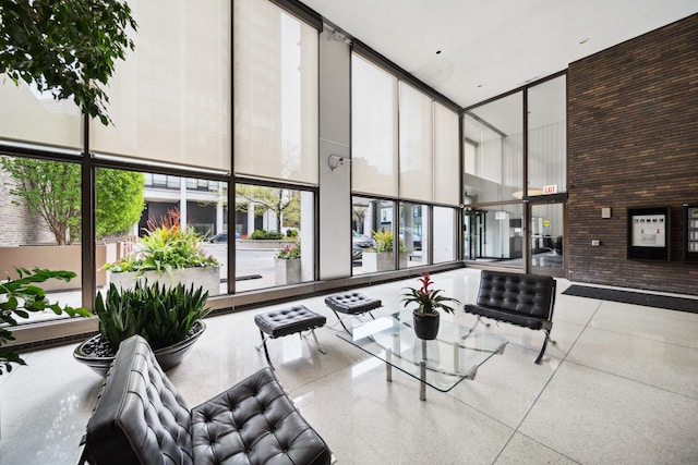 lobby with a high ceiling and a wall of windows
