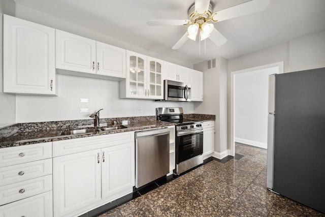 5455 N Sheridan Rd Unit 3804, Chicago, IL 60640 - kitchen featuring appliances with stainless steel finishes, a sink, glass insert cabinets, a ceiling fan, and white cabinets
