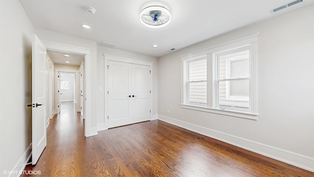 5524 W Byron St, Chicago, IL 60641 - unfurnished bedroom featuring baseboards, dark wood-style flooring, a closet, and recessed lighting