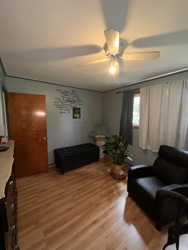 living room with light wood-style floors and ceiling fan