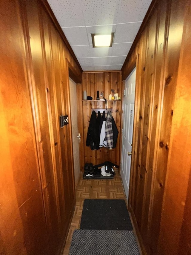 doorway featuring wooden walls