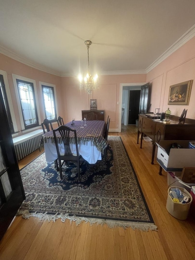 6108 N Maplewood Ave, Chicago, IL 60659 - dining area featuring ornamental molding, a chandelier, wood finished floors, and radiator heating unit