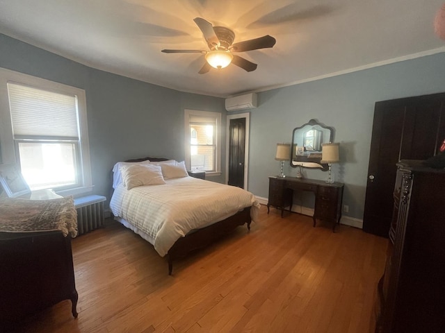 6108 N Maplewood Ave, Chicago, IL 60659 - bedroom with a wall unit AC, wood finished floors, ceiling fan, and baseboards