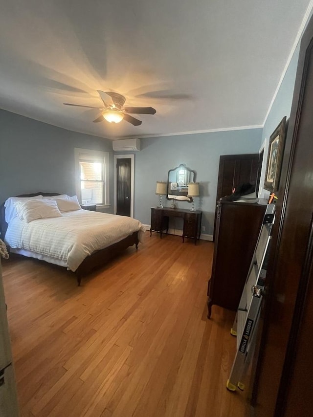 6108 N Maplewood Ave, Chicago, IL 60659 - bedroom with a wall unit AC, wood finished floors, baseboards, a ceiling fan, and ornamental molding