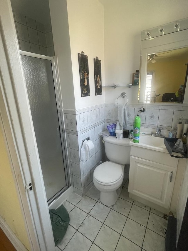 6108 N Maplewood Ave, Chicago, IL 60659 - bathroom featuring vanity, a shower stall, tile walls, toilet, and tile patterned floors