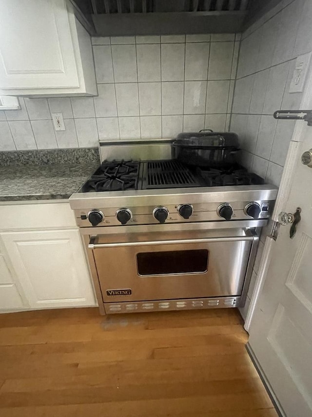 6108 N Maplewood Ave, Chicago, IL 60659 - kitchen view of luxury stove, tasteful backsplash, wood finished floors, and white cabinetry