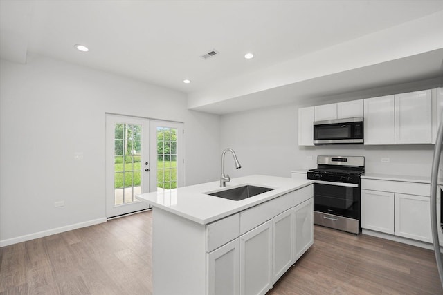 13723 S Springfield Ave, Robbins, IL 60472 - kitchen with appliances with stainless steel finishes, light wood-style flooring, light countertops, french doors, and recessed lighting