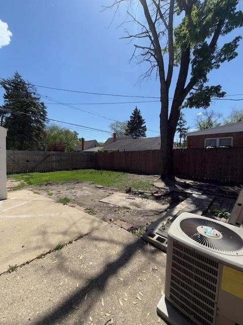 17545 Burnham Ave, Lansing, IL 60438 - fenced backyard featuring central AC and a patio area