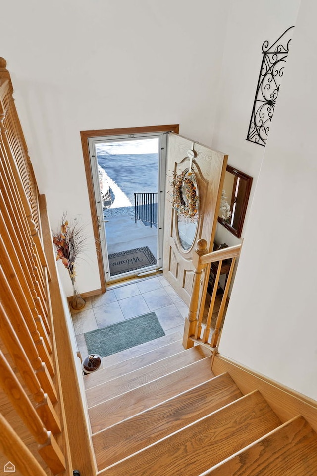 entryway featuring stairway and tile patterned floors