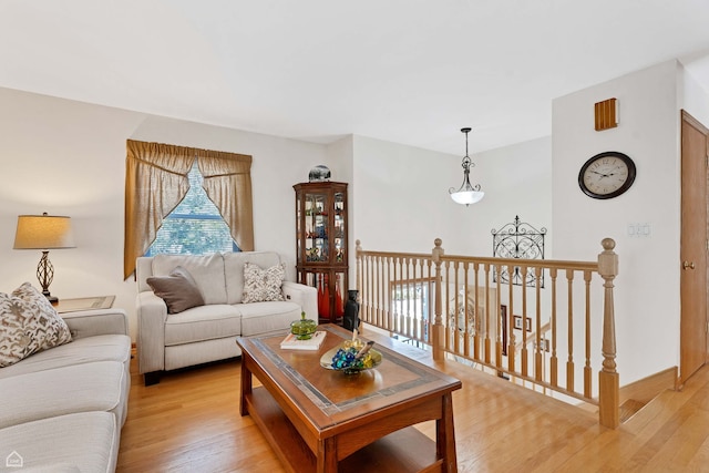 living room featuring light wood-style flooring and baseboards