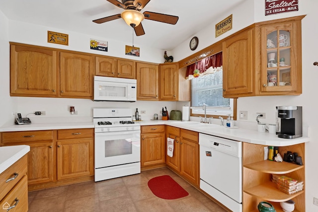 kitchen with white appliances, a sink, ceiling fan, and light countertops