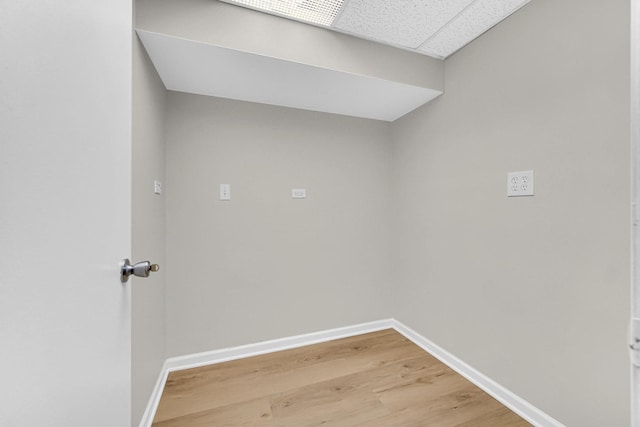 laundry room with baseboards and light wood-style flooring