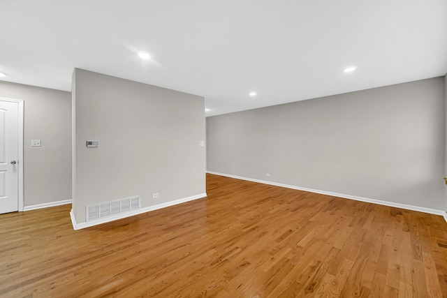 empty room with baseboards, light wood-style flooring, and recessed lighting