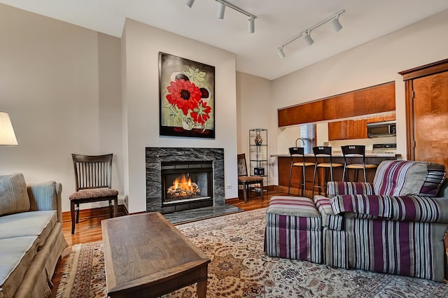 1050 W Buena Ave Unit 1A, Chicago, IL 60613 - living area featuring rail lighting, wood finished floors, and a warm lit fireplace