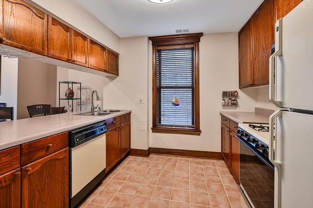 1050 W Buena Ave Unit 1A, Chicago, IL 60613 - kitchen featuring white appliances, a sink, light countertops, light tile patterned floors, and baseboards