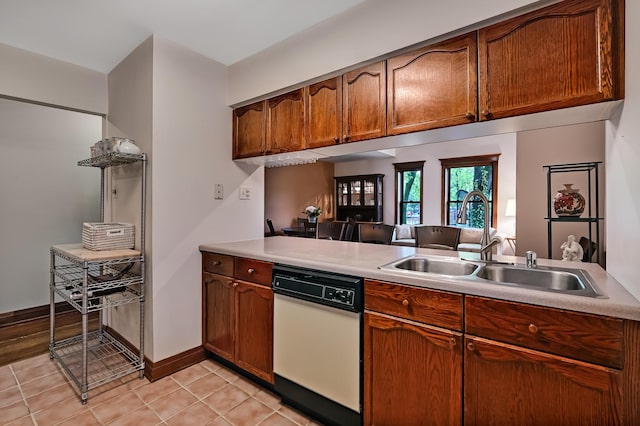 1050 W Buena Ave Unit 1A, Chicago, IL 60613 - kitchen with a sink, dishwasher, light countertops, light tile patterned flooring, and brown cabinets