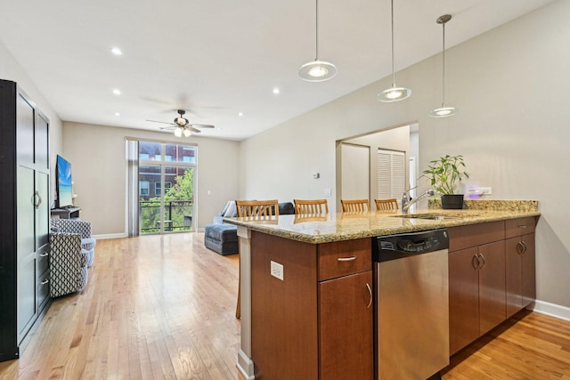 kitchen with dishwasher, light wood finished floors, a sink, a peninsula, and open floor plan