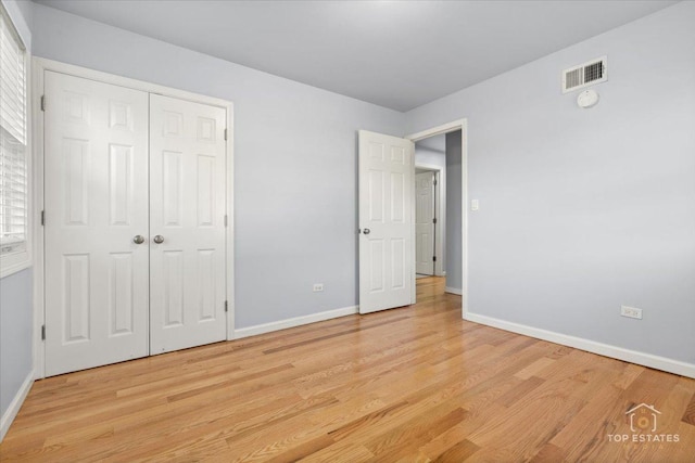 642 Gray Ct Unit 0, Wheeling, IL 60090 - unfurnished bedroom with light wood-style floors, baseboards, and a closet