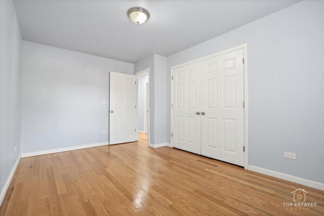 642 Gray Ct Unit 0, Wheeling, IL 60090 - unfurnished bedroom with baseboards, wood finished floors, and a closet