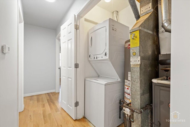 642 Gray Ct Unit 0, Wheeling, IL 60090 - clothes washing area featuring estacked washer and dryer, light wood-type flooring, and baseboards