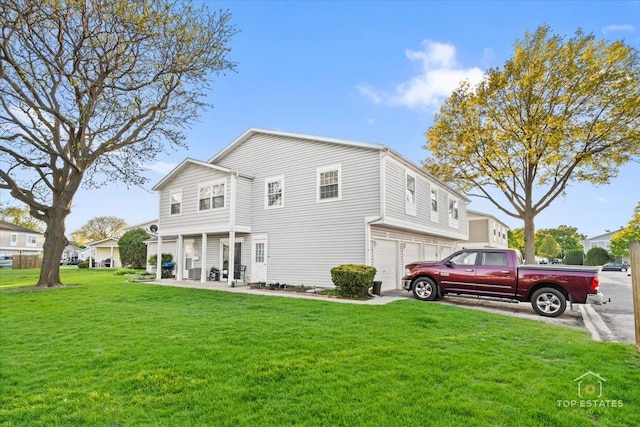 642 Gray Ct Unit 0, Wheeling, IL 60090 - rear view of house with an attached garage and a lawn