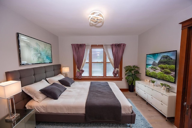 bedroom featuring light wood-style flooring and baseboards