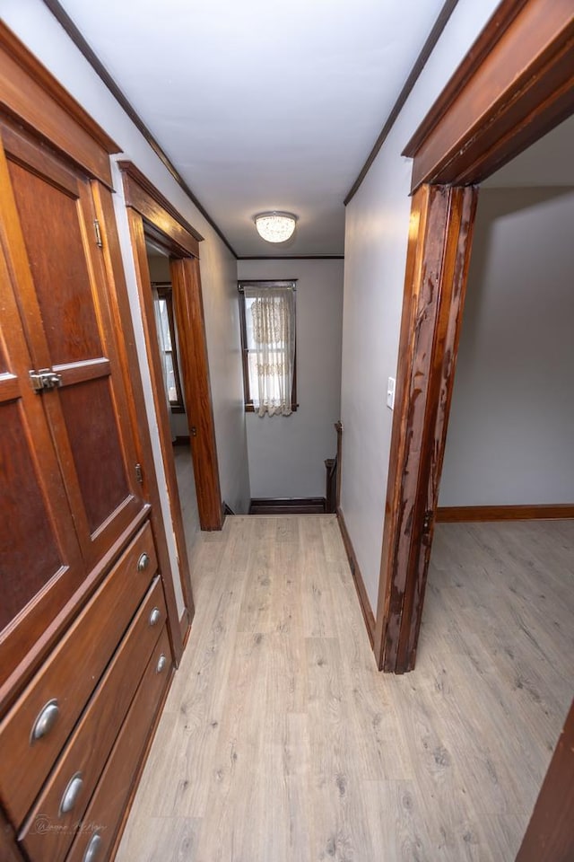hallway with light wood-style floors and baseboards