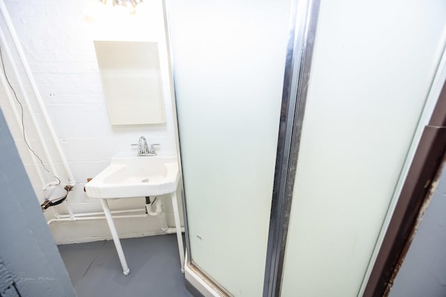 full bathroom featuring a shower stall and a sink