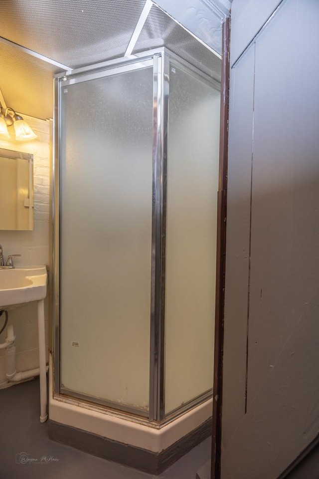 bathroom featuring a stall shower and concrete floors