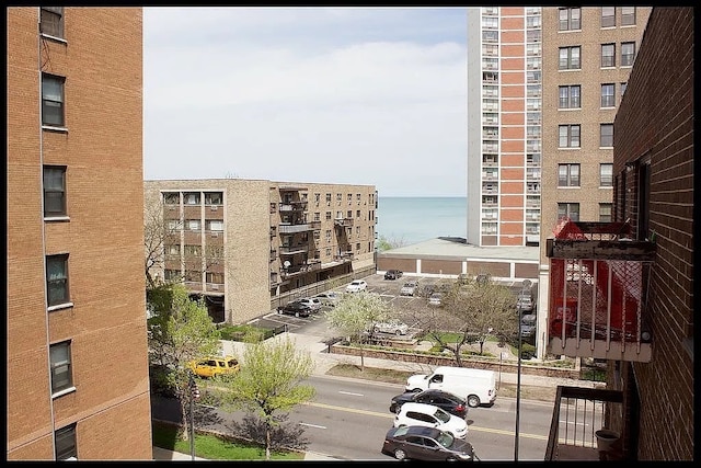 view of apartment building / complex with a water view