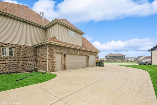 3140 Juniper Ct, Lynwood, IL 60411 - view of property exterior with brick siding, an attached garage, driveway, and a yard