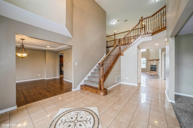 3140 Juniper Ct, Lynwood, IL 60411 - tiled entryway with baseboards, stairway, a high ceiling, a fireplace, and recessed lighting
