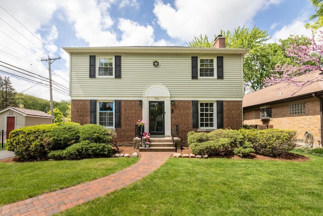 1116 S Aldine Ave, Park Ridge, IL 60068 - view of front facade with a chimney, a front yard, and brick siding