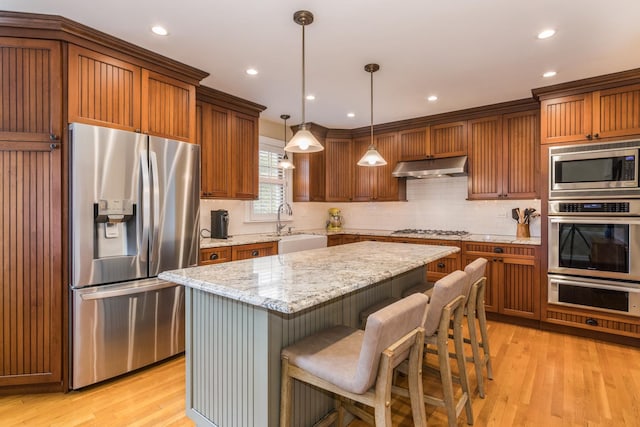 1116 S Aldine Ave, Park Ridge, IL 60068 - kitchen featuring stainless steel appliances, under cabinet range hood, a sink, a warming drawer, and a center island