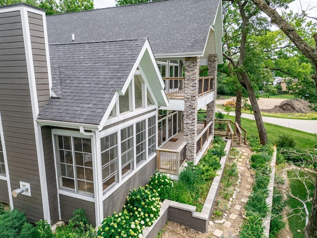 1124 Blackhawk Ave, Mchenry, IL 60051 - view of property exterior featuring roof with shingles and a sunroom