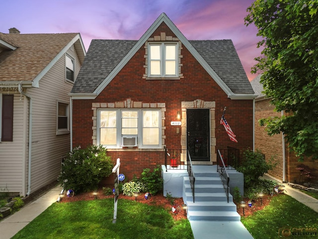 4112 N Mcvicker Ave, Chicago, IL 60634 - view of front of house with brick siding, roof with shingles, and cooling unit