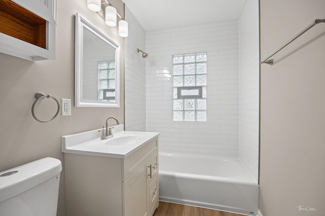 436 S Mckinley Ave, Kankakee, IL 60901 - full bath featuring toilet, shower / bath combination, wood finished floors, vanity, and plenty of natural light