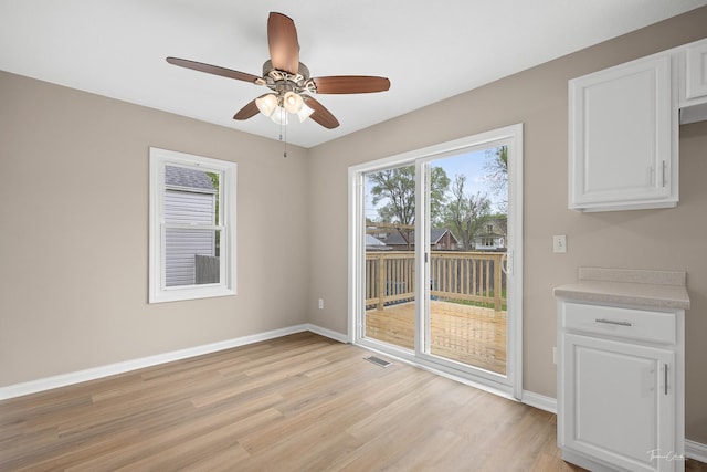 436 S Mckinley Ave, Kankakee, IL 60901 - unfurnished dining area featuring light wood-type flooring, baseboards, and a ceiling fan