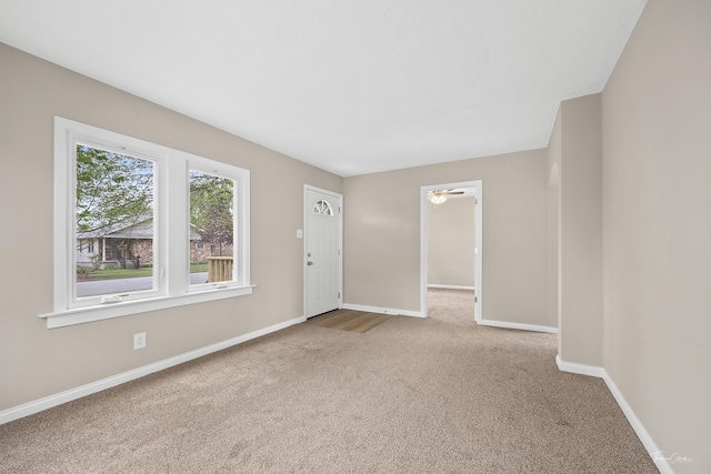 436 S Mckinley Ave, Kankakee, IL 60901 - unfurnished living room with carpet, baseboards, and ceiling fan