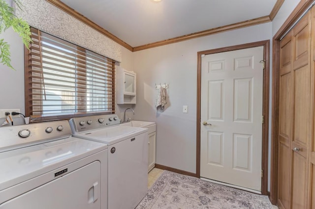 washroom featuring cabinet space, washing machine and dryer, and ornamental molding