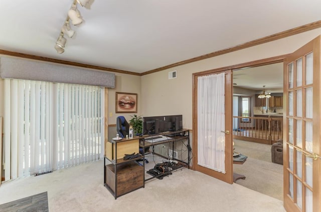 carpeted office space with french doors and crown molding