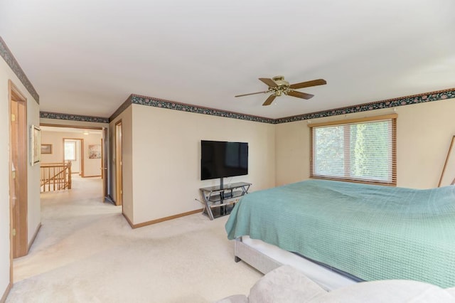 bedroom with baseboards, light carpet, and ceiling fan