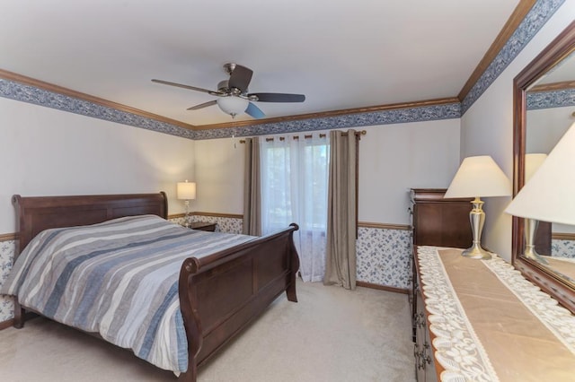 bedroom featuring crown molding, light carpet, and a ceiling fan