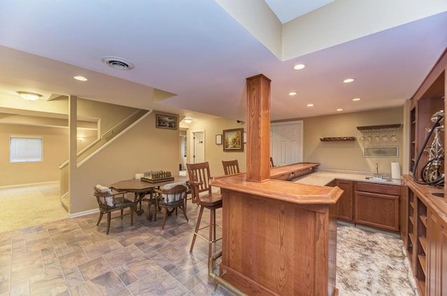 indoor wet bar featuring stairs, recessed lighting, baseboards, and light carpet