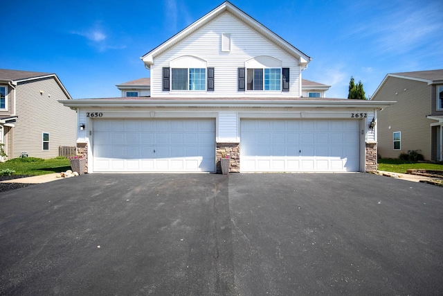 2650 Carlisle Ln, Hampshire, IL 60140 - traditional-style home featuring stone siding, asphalt driveway, an attached garage, and central air condition unit