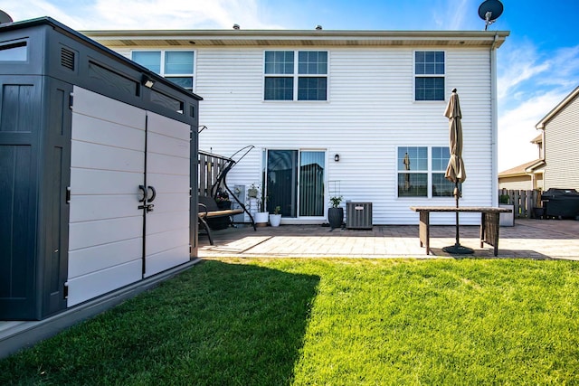 2650 Carlisle Ln, Hampshire, IL 60140 - back of property featuring a patio, a storage unit, a lawn, an outdoor structure, and central AC