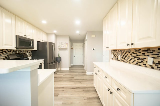 2650 Carlisle Ln, Hampshire, IL 60140 - kitchen with stainless steel appliances, backsplash, light wood-type flooring, white cabinetry, and baseboards