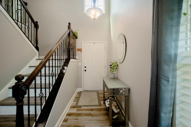 2650 Carlisle Ln, Hampshire, IL 60140 - foyer entrance with wood finished floors, a towering ceiling, stairs, and baseboards