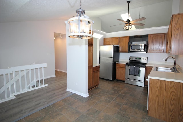 13340 S Oakview Ct Unit V2, Palos Heights, IL 60463 - kitchen featuring appliances with stainless steel finishes, a sink, brown cabinetry, vaulted ceiling, and a ceiling fan