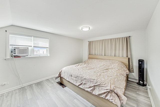 7715 W Patterson Ave, Chicago, IL 60634 - bedroom featuring baseboards, wood finished floors, cooling unit, and lofted ceiling